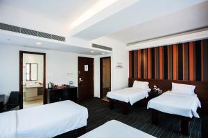 Giường trong phòng chung tại Le Prabelle Hotel