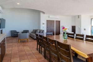 a living room with a large wooden table and chairs at Villa Costa Azul by Cabo Villas in San José del Cabo