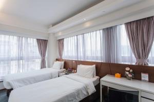 Giường trong phòng chung tại Le Prabelle Hotel