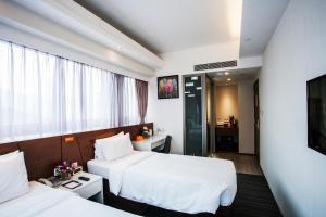 Giường trong phòng chung tại Le Prabelle Hotel