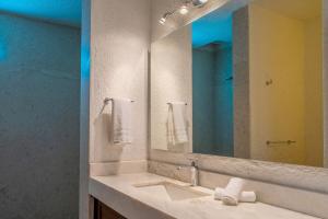 a bathroom with a sink and a large mirror at Villa Costa Azul by Cabo Villas in San José del Cabo +47 photos