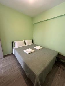 a bedroom with a bed with two towels on it at Konitsa Escape Apartment in Konitsa
