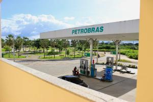 a gas station with a person at a gas pump at Pousada Carnaúbas - Sobral in Sobral