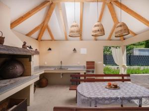 a kitchen with a table and a kitchen with wooden beams at House Madrino in Kreševo