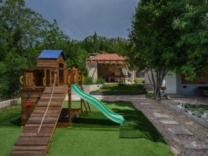 a playground with a slide in a yard at House Madrino in Kreševo