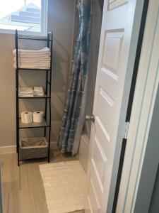 a bathroom door with a towel rack next to a window at Nanashortlet in Rosenberg