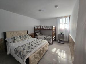 a bedroom with two beds and a bunk bed at Hotel Rodadero Dorado in Santa Marta +112 photos