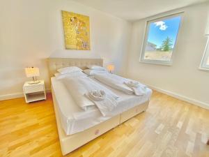 Uma cama ou camas num quarto em Steiner Residences Mödling