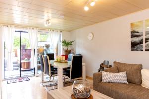 a living room with a table and a couch at Wellness Apartment Damm - 70 qm Komfort in Damm