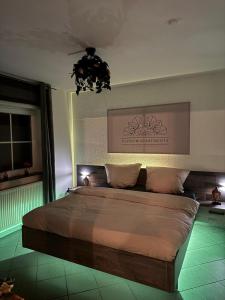 a bedroom with a large bed with a chandelier at Wellnesshaus - Whirlpool, Sauna, Küche, 24-7 in Herten