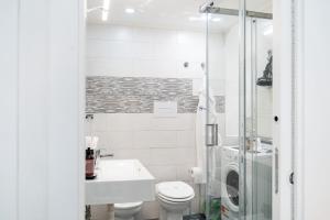 a bathroom with a toilet and a sink and a shower at Scugnizzo Apartment SMART in Naples +29 photos
