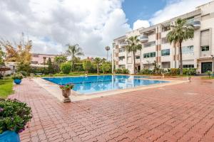 a swimming pool in front of a building at Apartment with sea view in Mohammedia