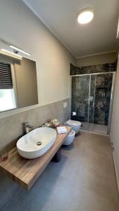 a bathroom with a sink and a toilet and a mirror at La Vista in Tavernola Bergamasca