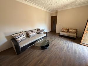 a room with a bed and a couch and a table at Central apartments Pleven in Pleven