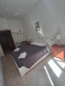 a bedroom with a bed with two towels on it at PM 27 Via Lanzo in Turin