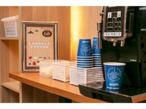a counter top with cups and a coffee machine at Smile Hotel Premium Sapporo Susukino - Vacation STAY 64521v in Sapporo