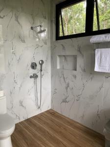 a bathroom with a shower and a toilet at Jako Doma Beachfront Cabana in San Francisco +37 photos