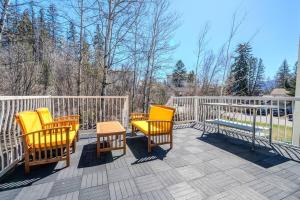 a group of chairs and a table on a deck at The Riverside Retreat at Fairmont in Fairmont Hot Springs