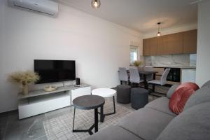 a living room with a couch and a dining room at Kuća za odmor Ana in Prozor