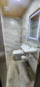 a bathroom with a sink and a toilet at Guest House Denis in Gjirokastër +71 photos
