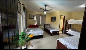 a bedroom with two beds and a ceiling fan at Pousada Summer Beach by Itaúna in Saquarema +152 photos