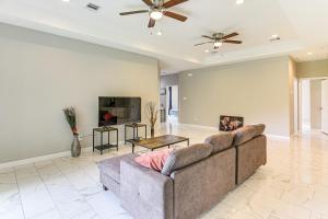 a living room with a couch and a ceiling fan at 11 Mi to Dtwn Houston Family Home with Yard in Houston