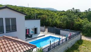 a swimming pool in the backyard of a house at Luksuzna kuća za odmor "Villa Romantica" in Kraljevica