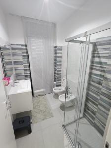 a bathroom with a shower and a toilet and a sink at Wolfy's Apartment in San Benedetto del Tronto