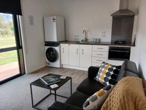 a living room with a couch and a kitchen at Suncrest Villas in Cromwell