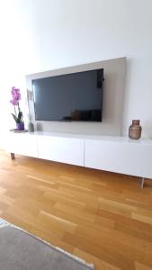 a flat screen tv on a white wall in a living room at Meandar Luxury Apartment in Sarajevo
