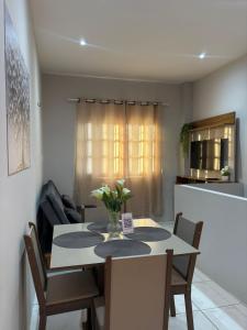 a dining room with a table and chairs and a kitchen at Rodrigues AP Apartamento em Barreirinhas in Barreirinhas +10 photos