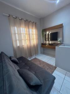 a bedroom with a large bed and a flat screen tv at Rodrigues AP Apartamento em Barreirinhas in Barreirinhas
