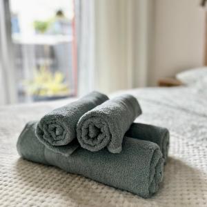a pile of towels sitting on top of a bed at Apartment Chrzanòw in Chrzanów