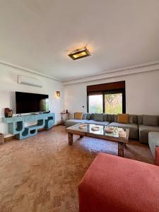 a living room with a couch and a coffee table at Villa Cactus & chill - Breakfast included! in Marrakech
