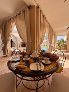 a table with food on it in a living room at Villa Cactus & chill - Breakfast included! in Marrakech