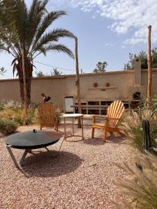 a patio with two chairs and a table at Villa Cactus & chill - Breakfast included! in Marrakech +48 photos