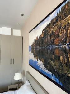 a large painting hanging on a wall in a bedroom at Villa Harmony in Ohrid