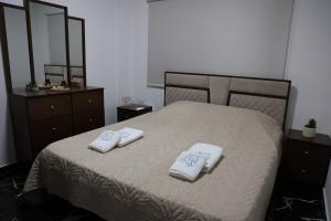 a bedroom with a bed with two towels on it at Sky High Guesthouse in Gharīfah +20 photos
