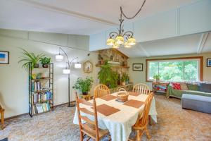a dining room and living room with a table and chairs at 8 Mi to Crystal Mountain Peaceful Up North Home in Thompsonville