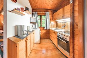 a kitchen with wooden floors and wooden cabinets at Bergcottage in Neerdar
