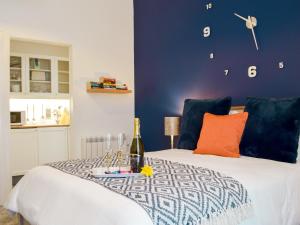 ein Schlafzimmer mit einem Bett mit einer Flasche Wein darauf in der Unterkunft Little Fishes in Tenby