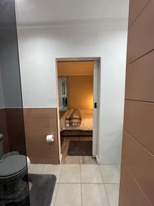 a bathroom with a bed in a room at The Apartment on Risa in Emerald Hill +17 photos