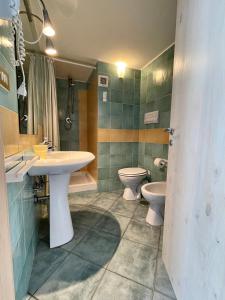 a bathroom with a sink and a toilet and a sink at Casa Trama in Pisciotta