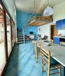 a kitchen with blue tile floors and a table and chairs at Casa Trama in Pisciotta