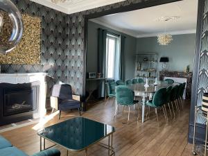 a living room with a table and chairs and a fireplace at La Maison de Martha in Jaunay-Clan