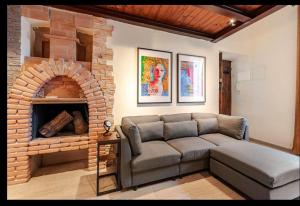 a living room with a couch and a brick fireplace at Spoleto between past, art, music in Spoleto