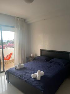 a bedroom with a bed with two white towels on it at Résidence calme et luxueuse in Dar Bouazza +10 photos