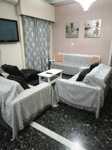 a living room with two couches and a couch at Mitropoli's Home in Leonidion +32 photos