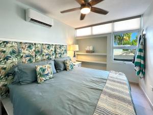 a bedroom with a large bed with a ceiling fan at Condado Laguna Villa 1 - Spa - 6 Bd 3Ba Generator in San Juan