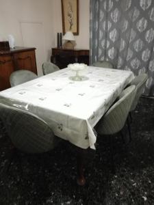 a table with a white table cloth on it at Mitropoli's Home in Leonidion